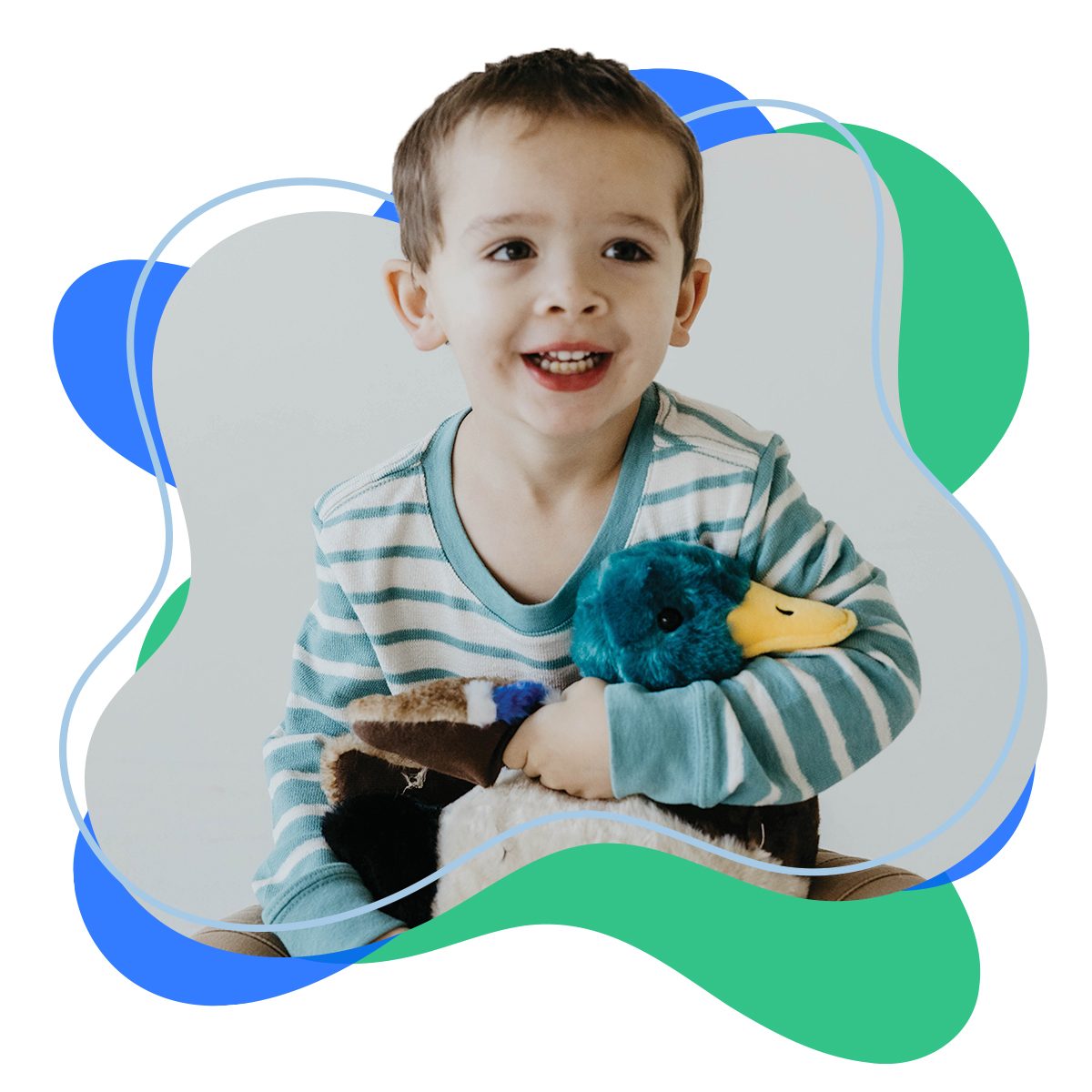 A smiling boy hugging a Zoologee cow plush toy