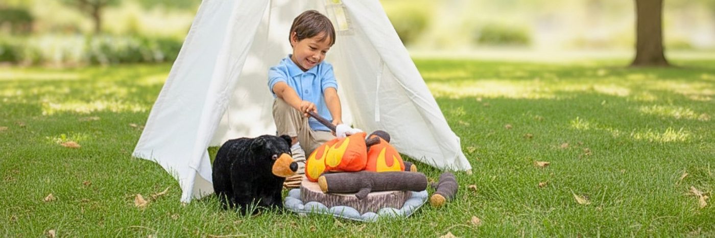Children playing with plush animals inside a garden teepee