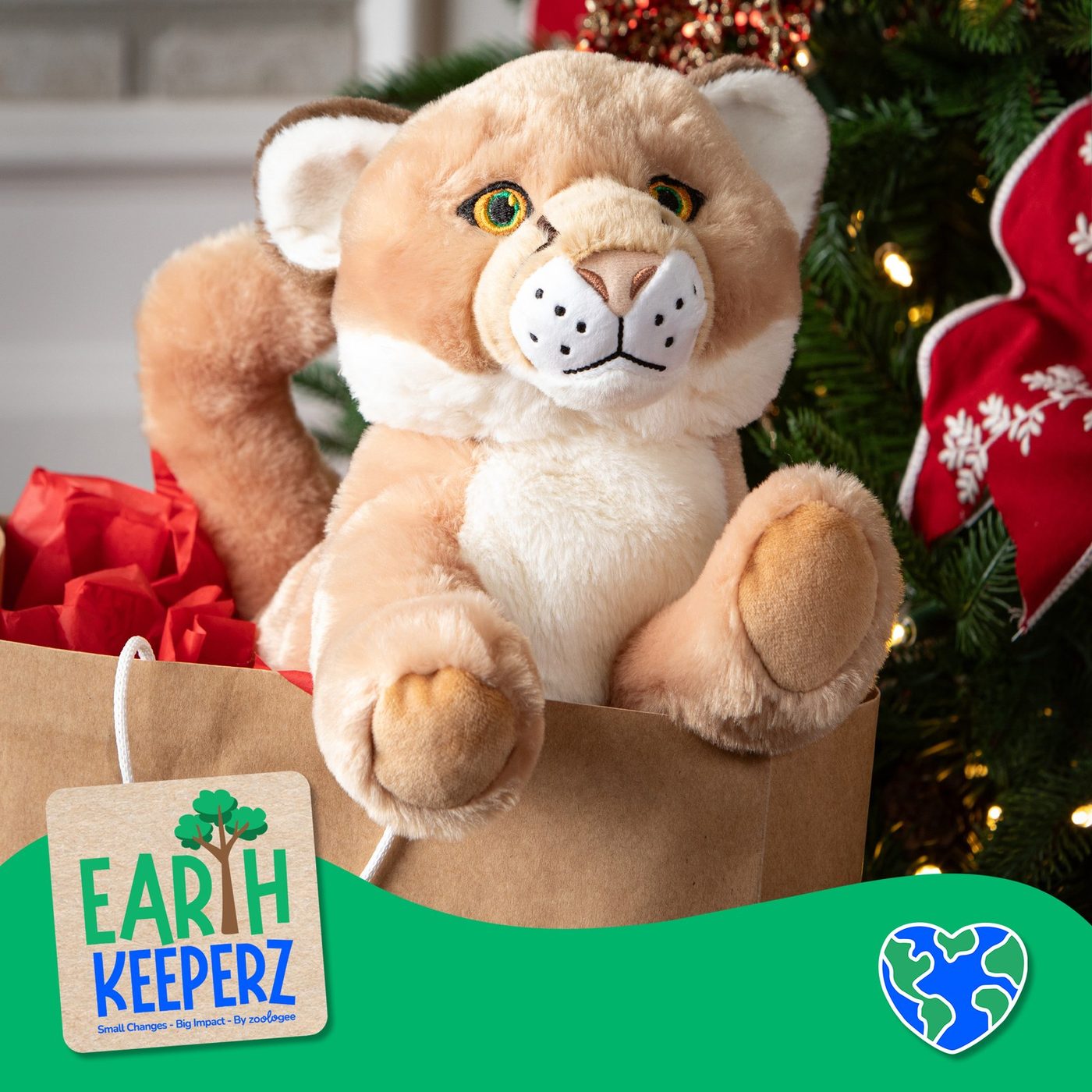 An Earth Keeperz cougar plush toy beside a green gift bag