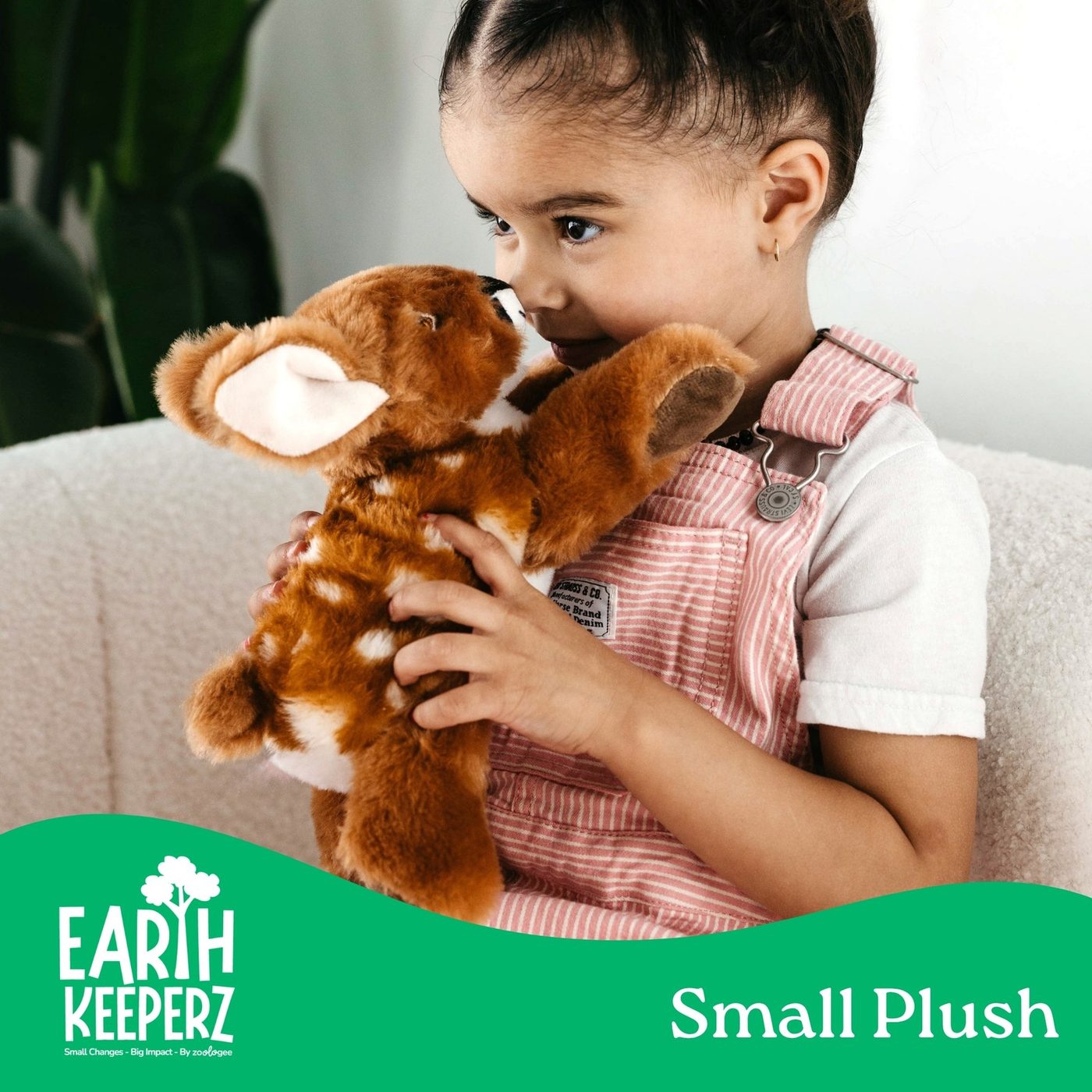 An Earth Keeperz small plush fox being hugged by a child